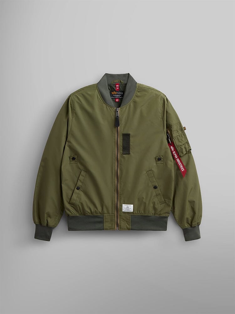 Alpha Industries L-2B Skymaster Gen II Bomber Jacket, OG-107 Green, lightweight nylon, front zipper, ribbed cuffs and hem, sleeve pocket with oxygen tab detail, red Remove Before Flight tag.