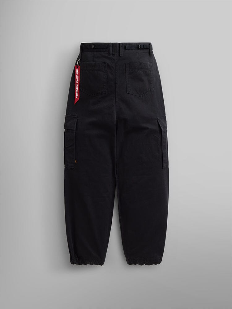 Alpha Industries M-65 Cargo Pant Womens in black with multiple pockets, elastic cuffs, and a red tag on a belt loop.