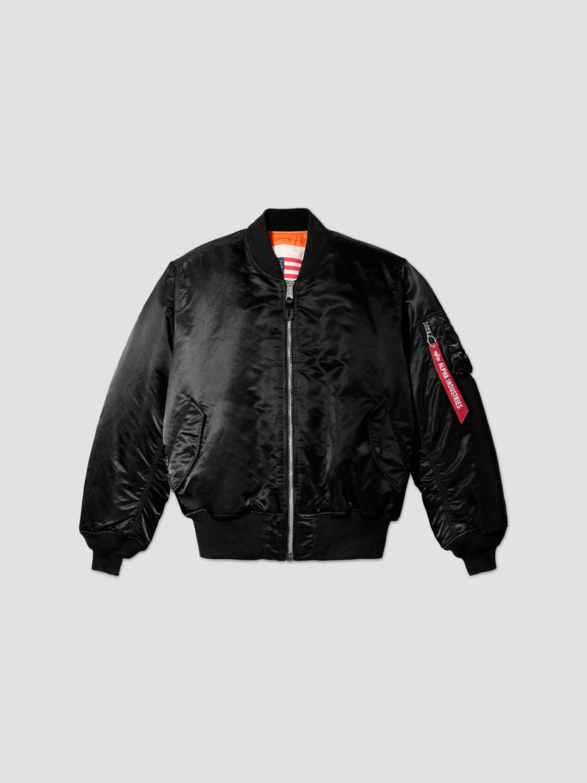 Alpha Industries MA-1 Blood Chit: black flight jacket, front zipper, ribbed cuffs and hem, two front pockets, sleeve zip pocket with red tag.