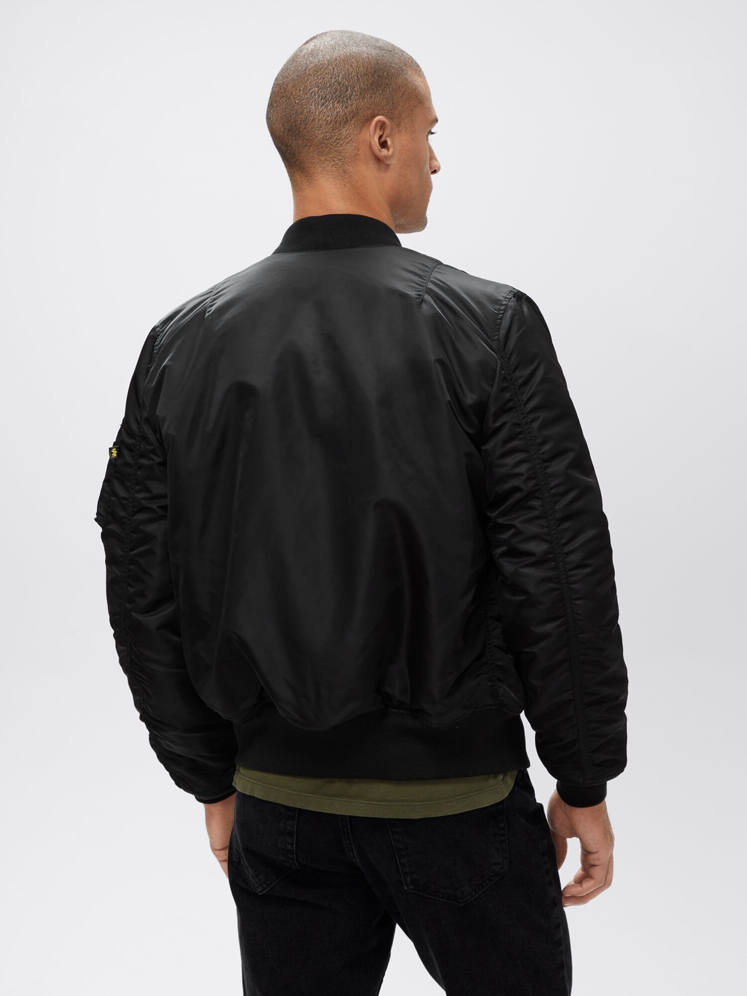 Back view of black Alpha Industries MA-1 Bomber Jacket Slim Fit showing ribbed collar, cuffs, and waistband.