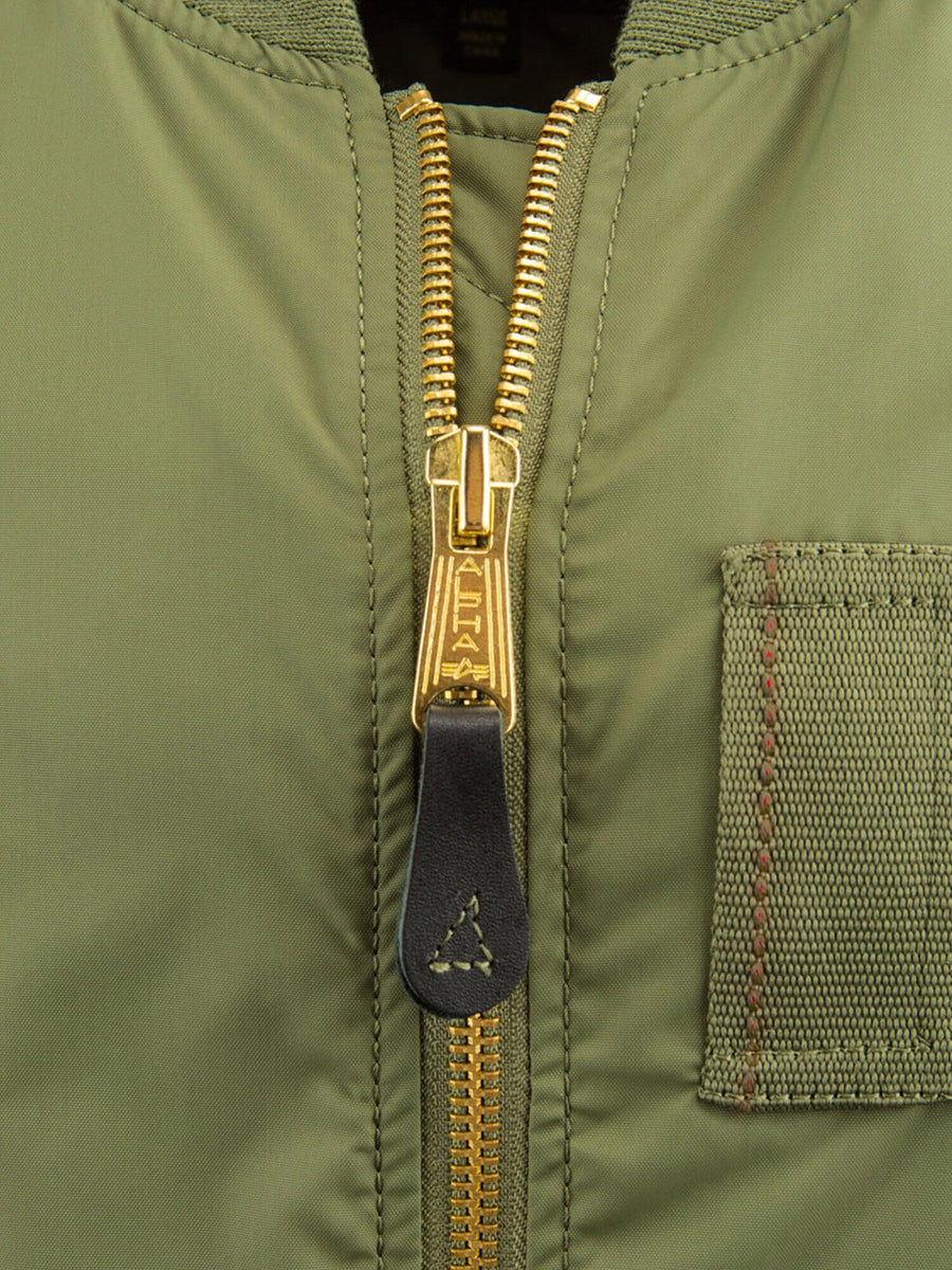 Alpha Industries MA-1 Skymaster Bomber Jacket in olive green with gold zipper, black pull tab, and stitched right pocket.