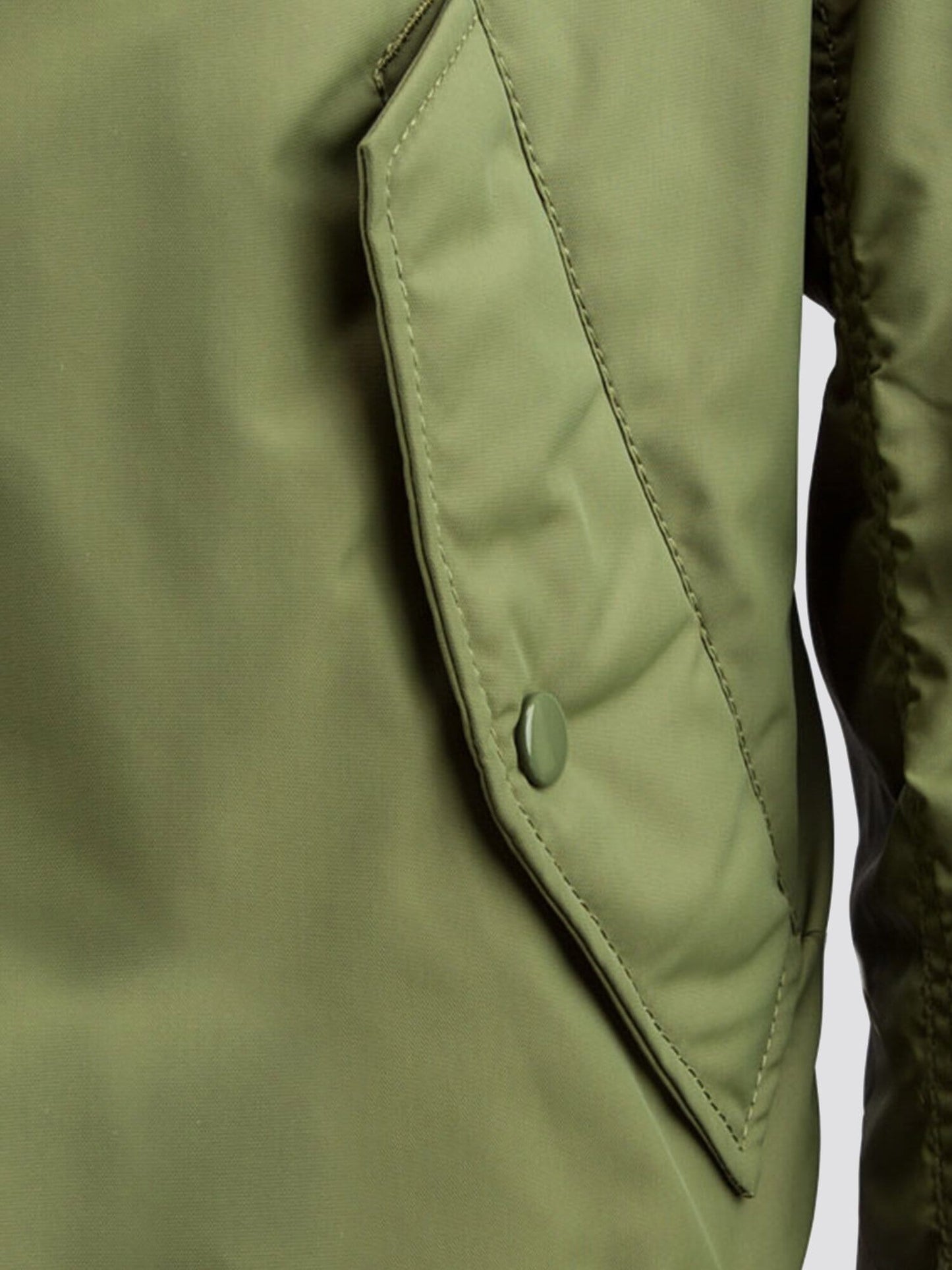 MA-1 Skymaster Bomber Jacket by Alpha Industries in olive green with buttoned flap pocket and lightweight outerwear details.