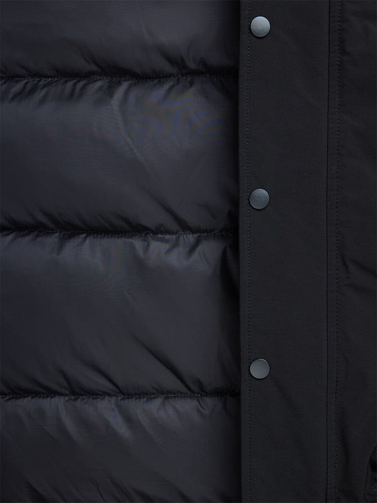 Close-up of a black padded N-2B Altitude Parka from Alpha Industries, featuring button snaps on the right edge and a water-resistant finish.