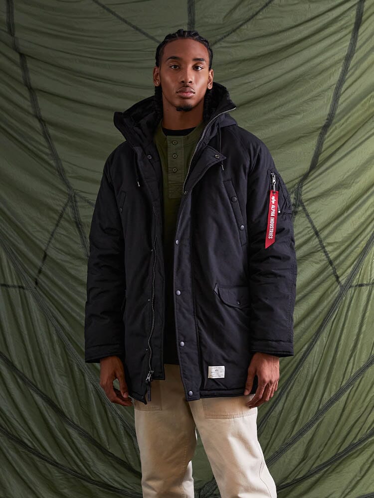 A person wearing the N-3B Altitude Mod Parka in black, by Alpha Industries.