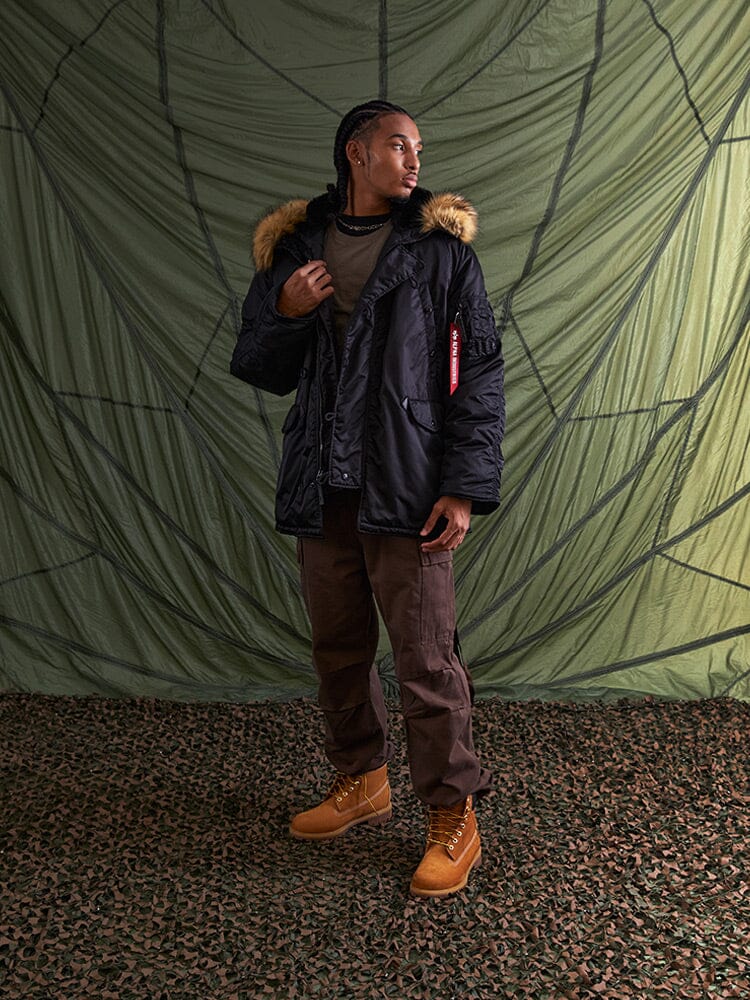 Alpha Industries N-3B Parka in black, nylon material, front zipper and button closures, hooded design.