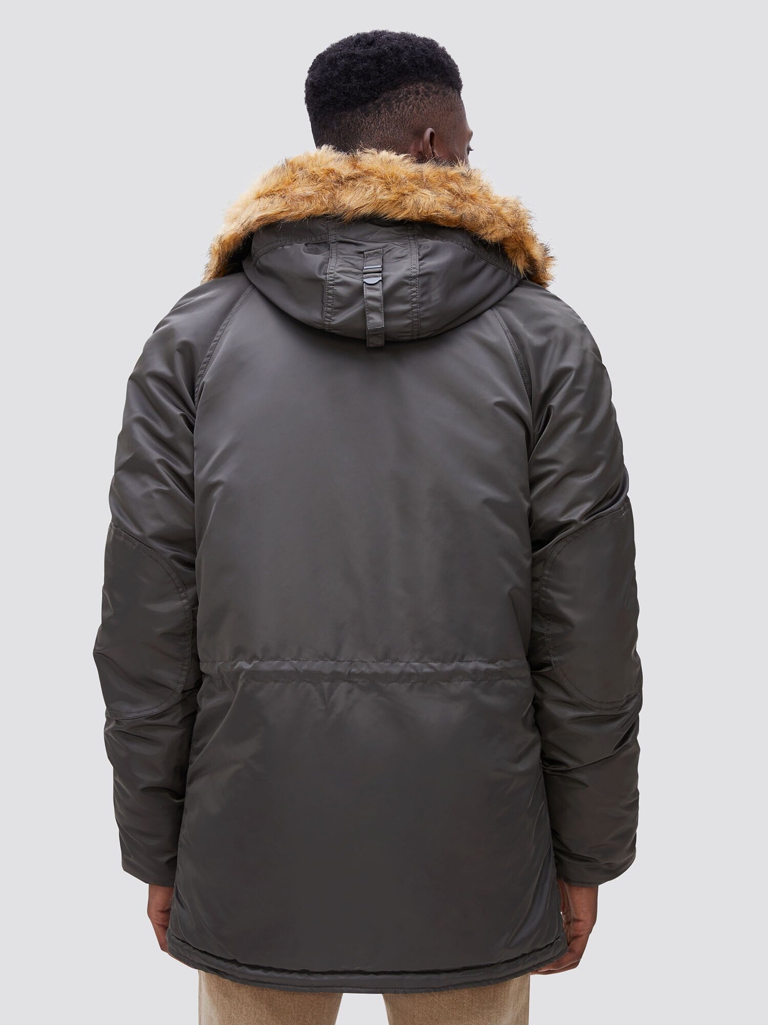 Alpha Industries N-3B Slim Gen I Parka in dark green with faux fur trim.