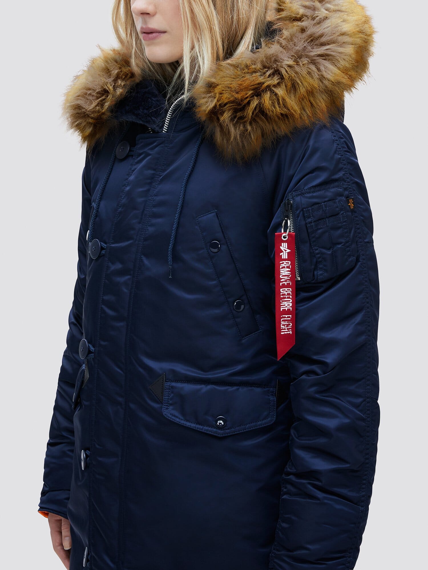 Alpha Industries N-3B Womens Parka, navy blue, fur-lined snorkel hood, red Remove Before Flight tag on utility pocket.