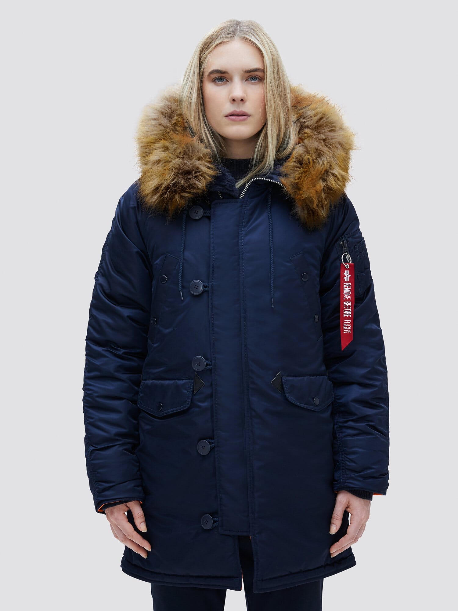 Alpha Industries N-3b Womens Parka, navy blue, fur-trimmed snorkel hood, utility pocket, red tag on left sleeve.