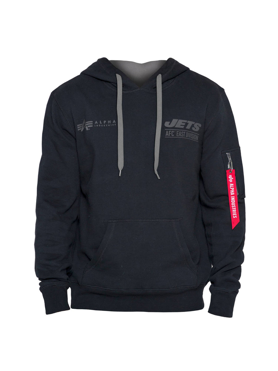 The New York Jets X Alpha X New Era Hoodie, created by Alpha Industries and NE-NFL, is a black pullover adorned with the Jets AFC East Division logos. It boasts sleek gray drawstrings and features the signature red tag on the left sleeve.