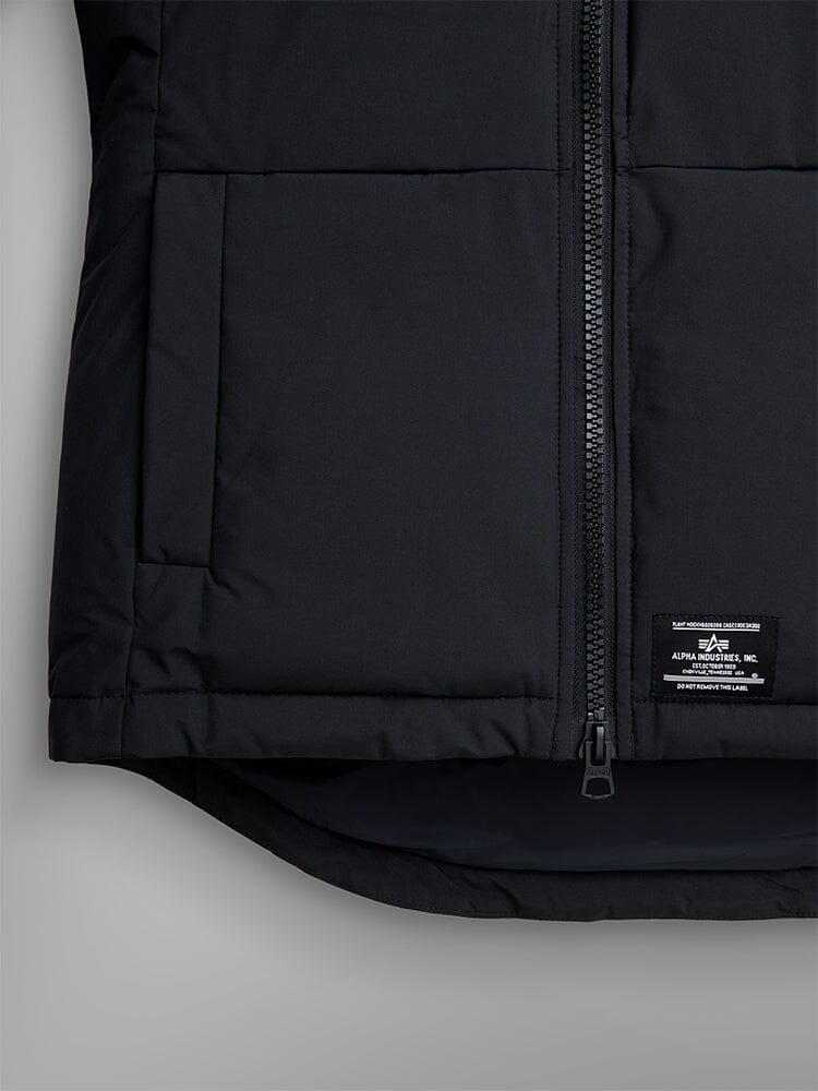 Alpha Industries Short Parka W, black quilted jacket with utility pockets, front zipper, small label near hem.