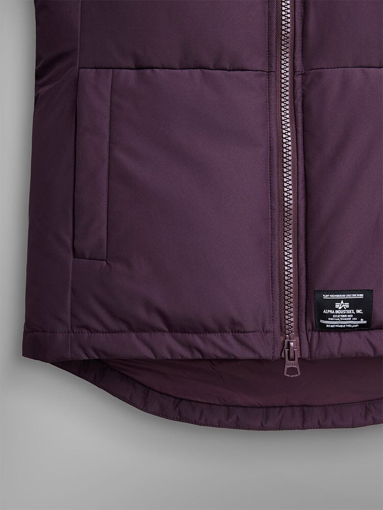 Alpha Industries Short Parka W in maroon with quilting, front zipper, utility and side pockets, black brand label near hem.
