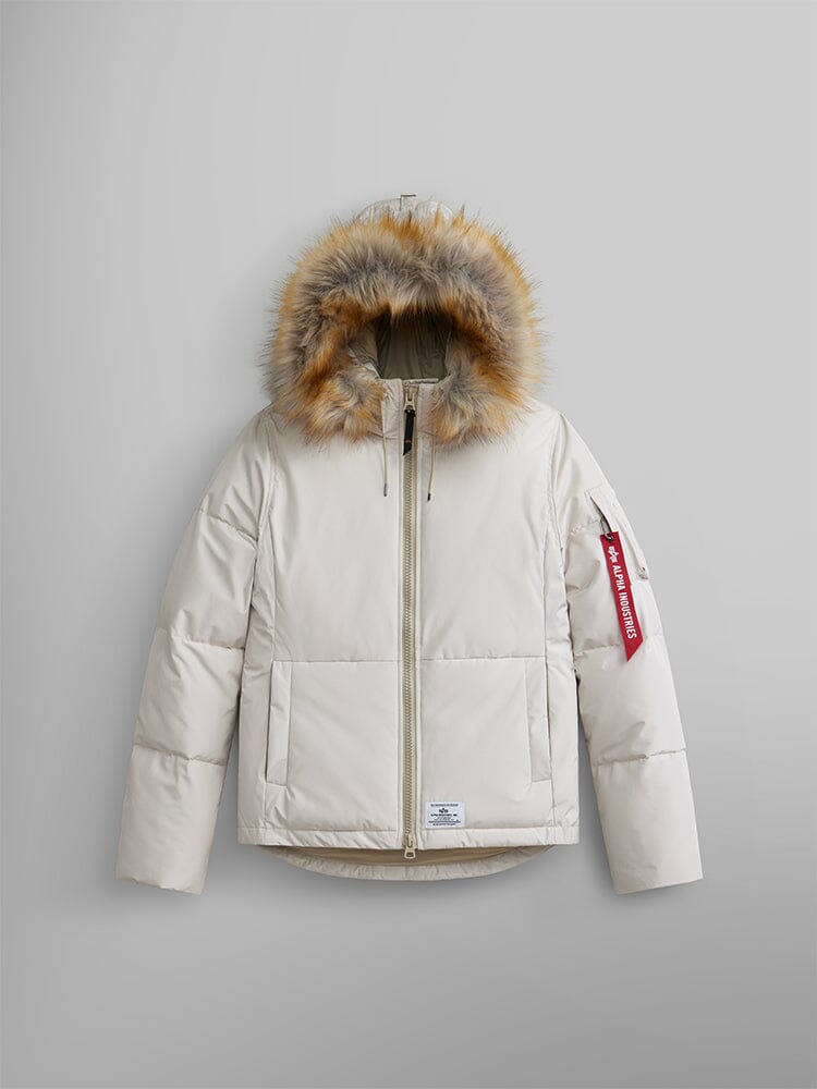 Alpha Industries Short Parka W in Limestone with faux fur hood, front zipper, utility pockets, and red Remove Before Flight sleeve tag.