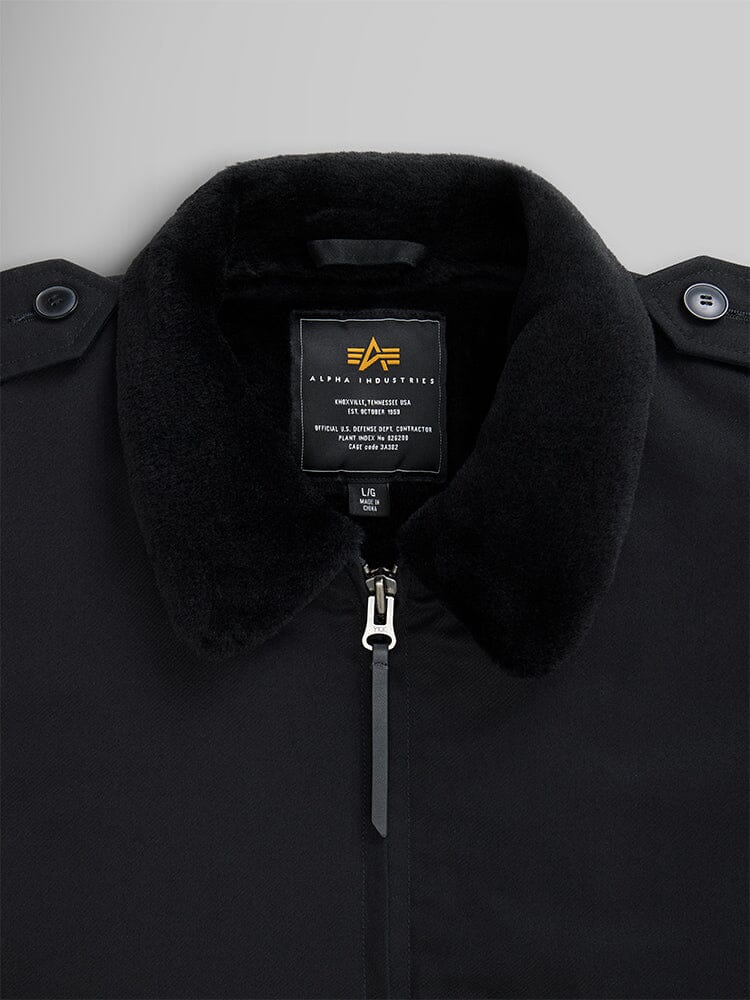 Close-up of a 1940s B-10 Bomber Jacket in black, showcasing a fuzzy collar and full-zip front that evokes the classic flight jacket style. The label proudly reads Alpha Industries.