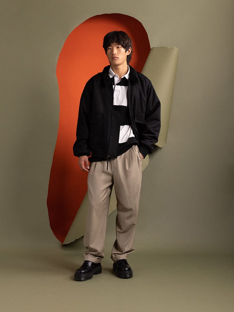 A person in the 1940s B-10 Bomber Jacket in black by Alpha Industries.