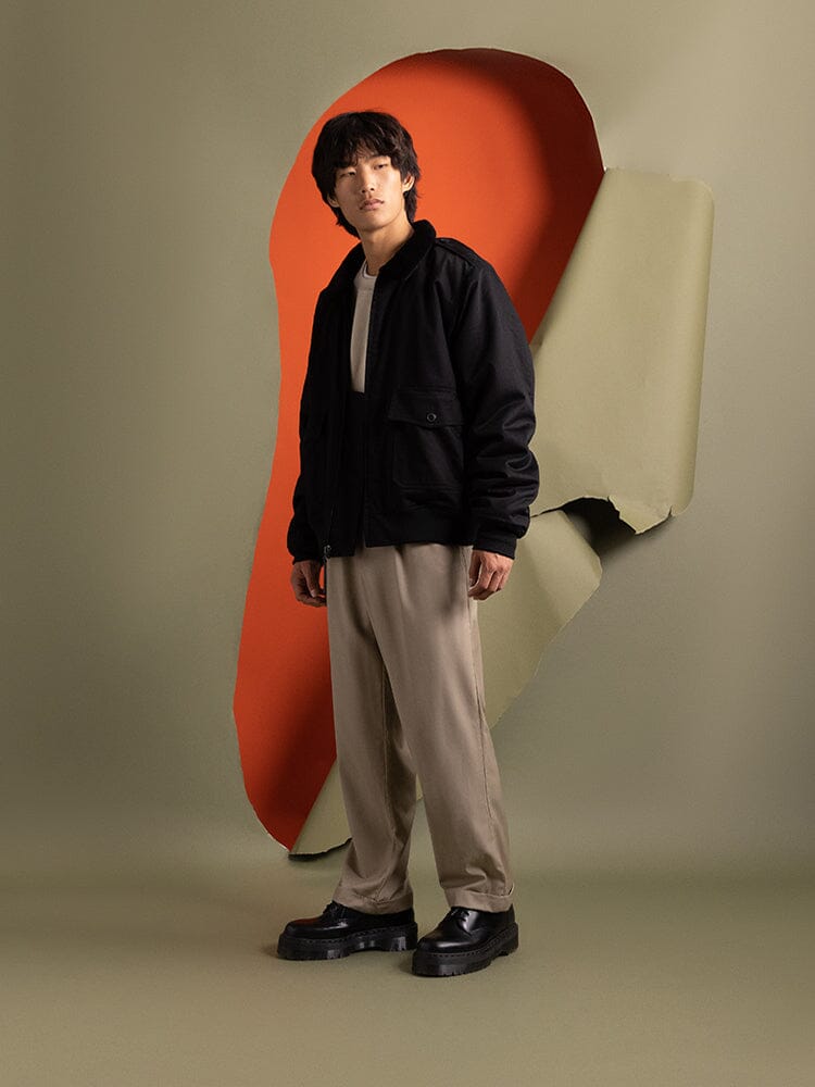 Side-view of a person wearing an  1940s B-10 Bomber Jacket by Alpha Industries.