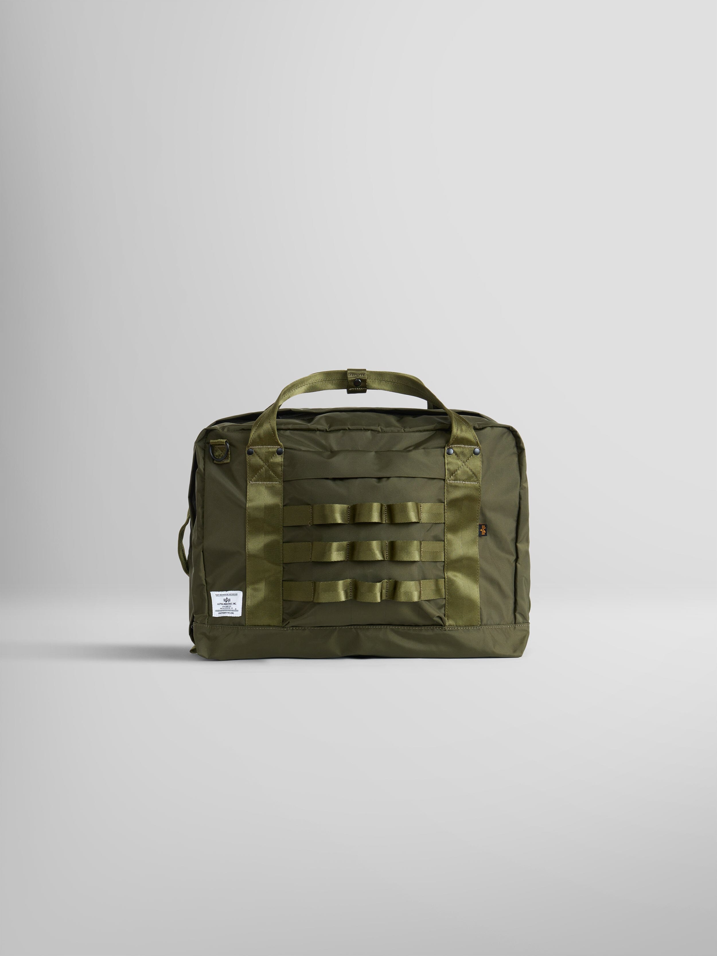 Alpha Industries 24 Hr Bag, olive green nylon, dual handles, front MOLLE webbing, small white label on lower left corner.