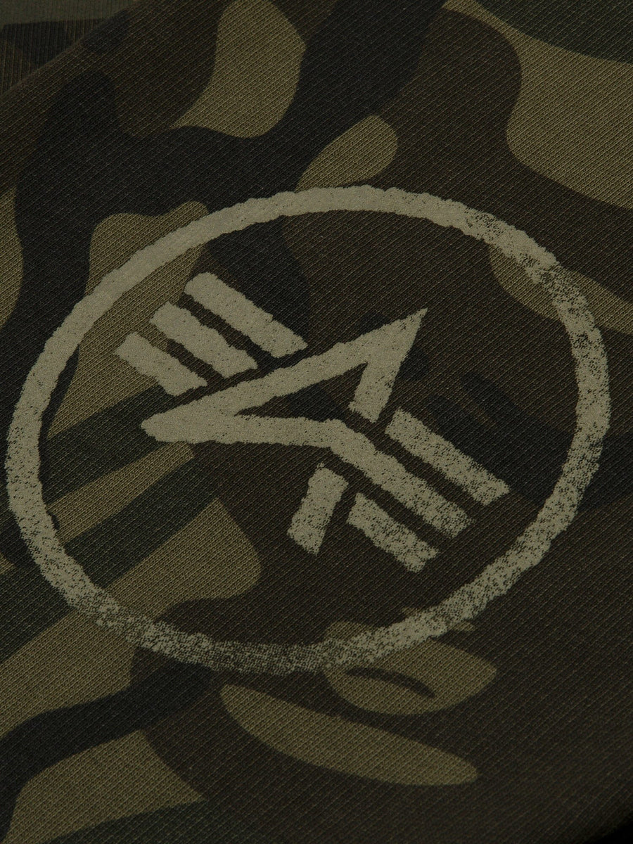 Aape X Alpha Camo Crewneck Sweatshirt by Alpha Industries, camouflage fabric, circular emblem with stylized “A” and three parallel lines.
