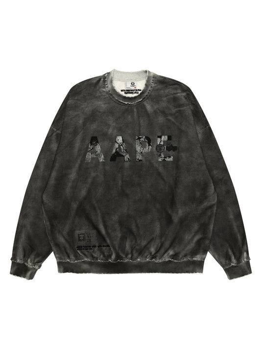 Aape X Alpha Crewneck Sweatshirt by Alpha Industries in black with patterned AAPE lettering on front and small tag near bottom hem.