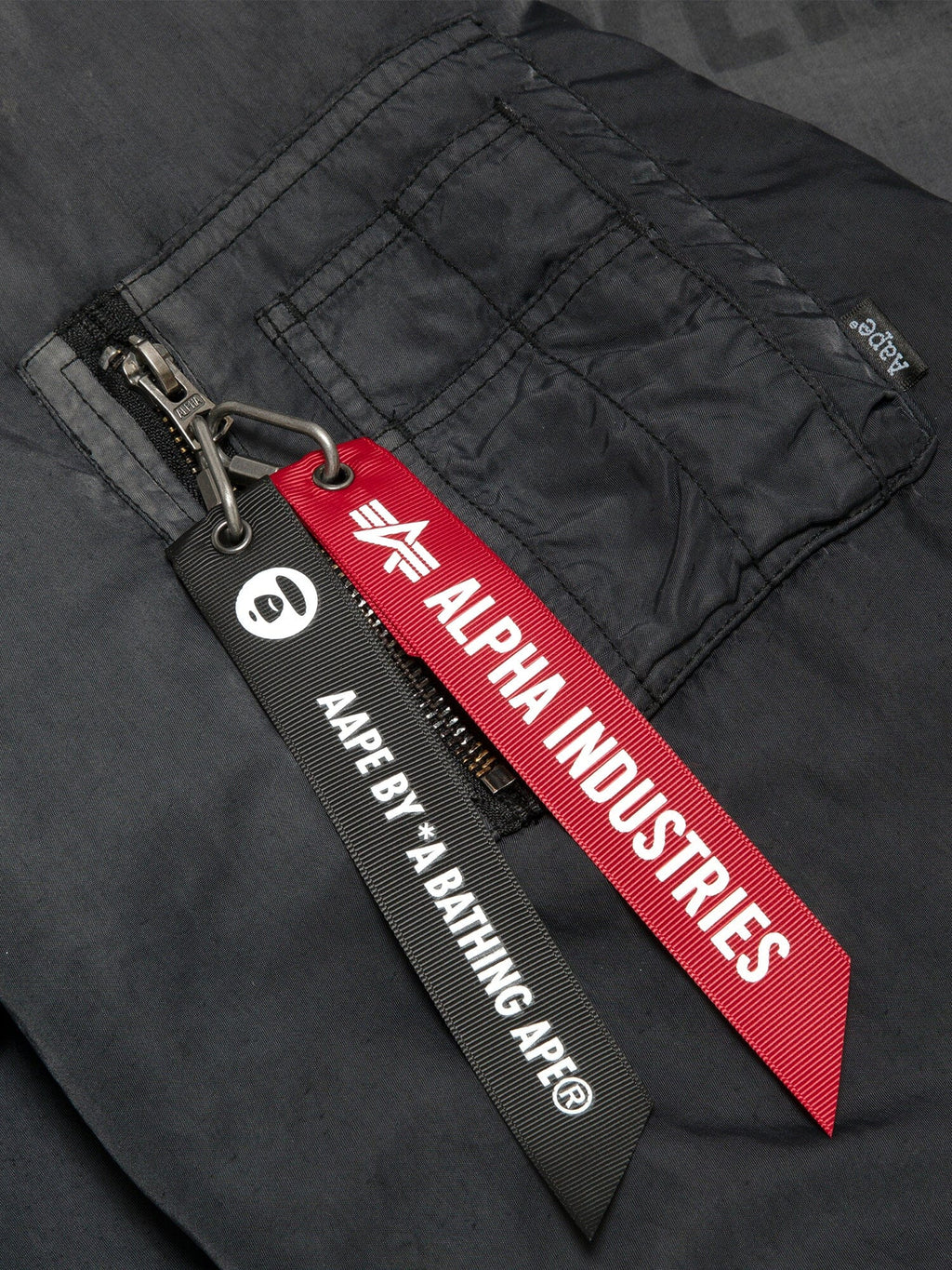 Aape X Alpha Reversible Padded MA-1 Quilted Jacket by Alpha Industries, black, zipper closure with red Alpha Industries tag and black Aape By *A Bathing Ape® tag.
