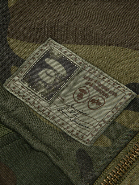 Aape X Alpha Reversible Padded MA-1 Quilted Jacket by Alpha Industries, camouflage, stitched logo patch, signature detail, visible zipper.
