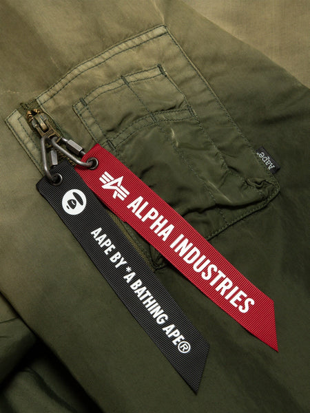 Aape X Alpha Reversible Padded MA-1 Quilted Jacket by Alpha Industries, green pocket with two keychains: red Alpha Industries and black Aape By *A Bathing Ape.