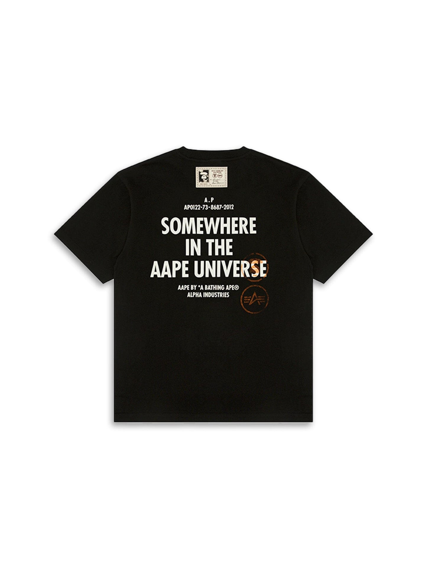 The AAPE X Alpha Somewhere In Universe Tee By Alpha Industries; Features Somewhere in the AAPE Universe Text And Branding on the back.