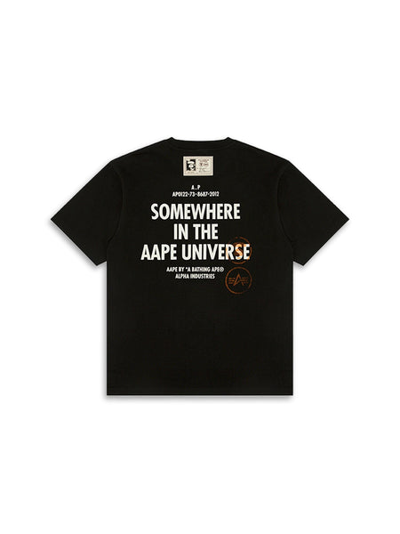 The AAPE X Alpha Somewhere In Universe Tee By Alpha Industries; Features Somewhere in the AAPE Universe Text And Branding on the back.