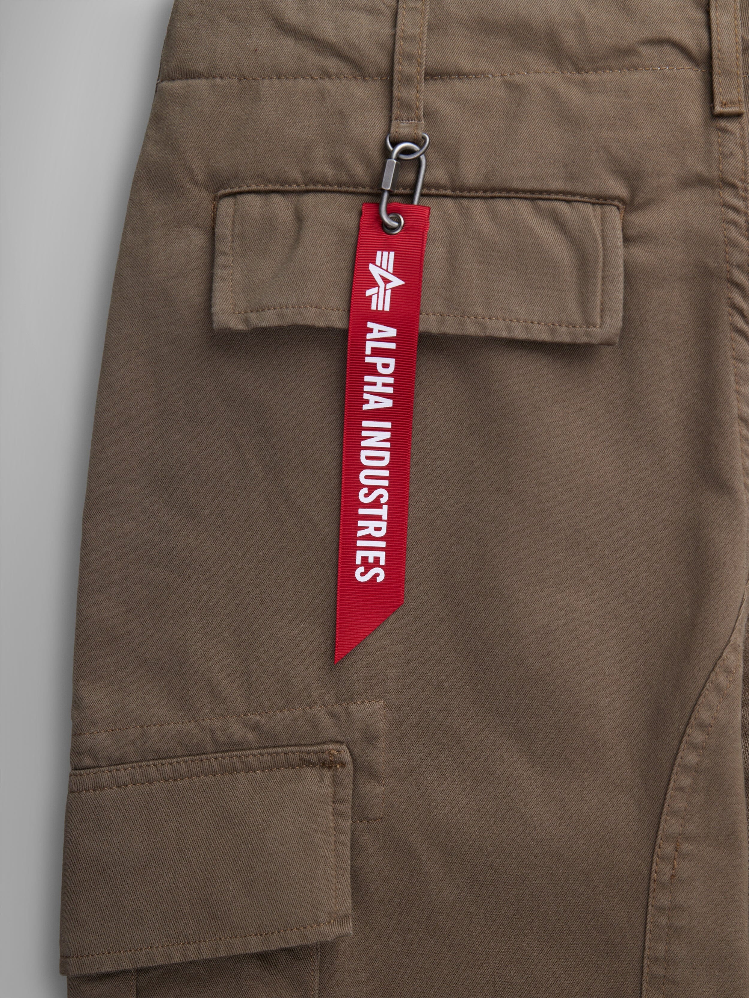 Alpha Industries Acu Pant Coyote Brown, Utility Pockets, Pocket With Red Alpha Industries Tag Attached By Metal Clasp.