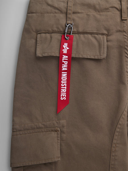 Alpha Industries Acu Pant Coyote Brown, Utility Pockets, Pocket With Red Alpha Industries Tag Attached By Metal Clasp.