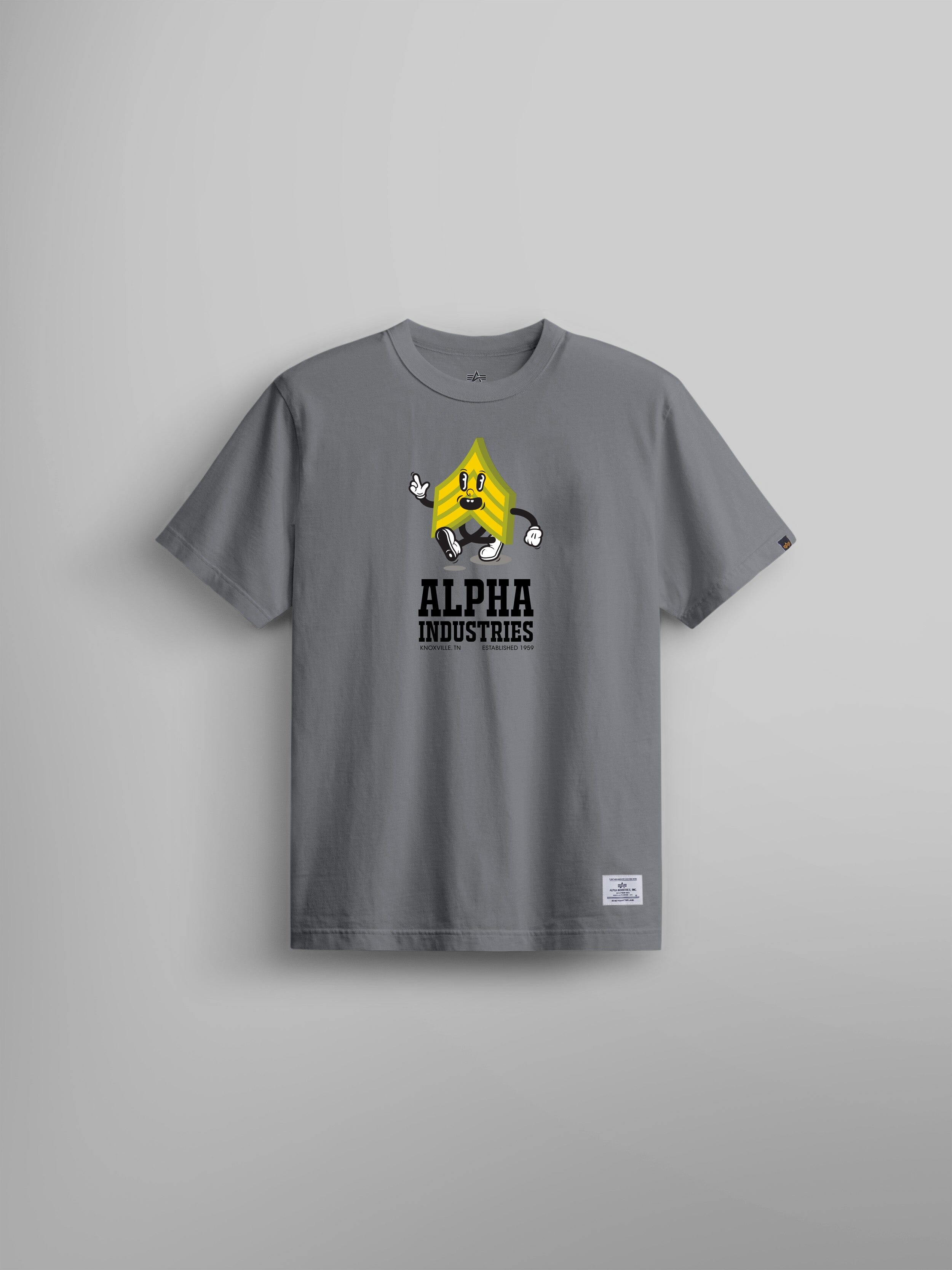 Alpha Badge Tee by Alpha Industries, aircraft gray t-shirt with yellow cartoon character graphic and Alpha Industries text on chest.