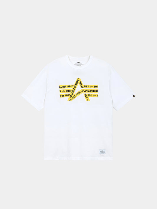 Alpha Caution Tape Tee by Alpha Industries is a white short-sleeve t-shirt with a yellow caution tape graphic and logo text on front.