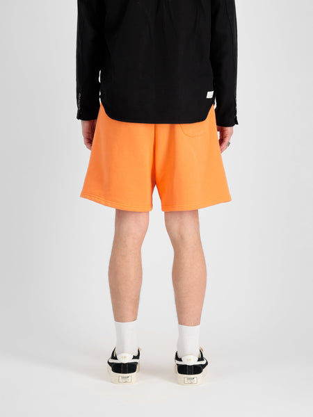 Alpha Essential Relaxed Short by Alpha Industries in bright orange, soft cotton blend, elastic waistband, side pockets.