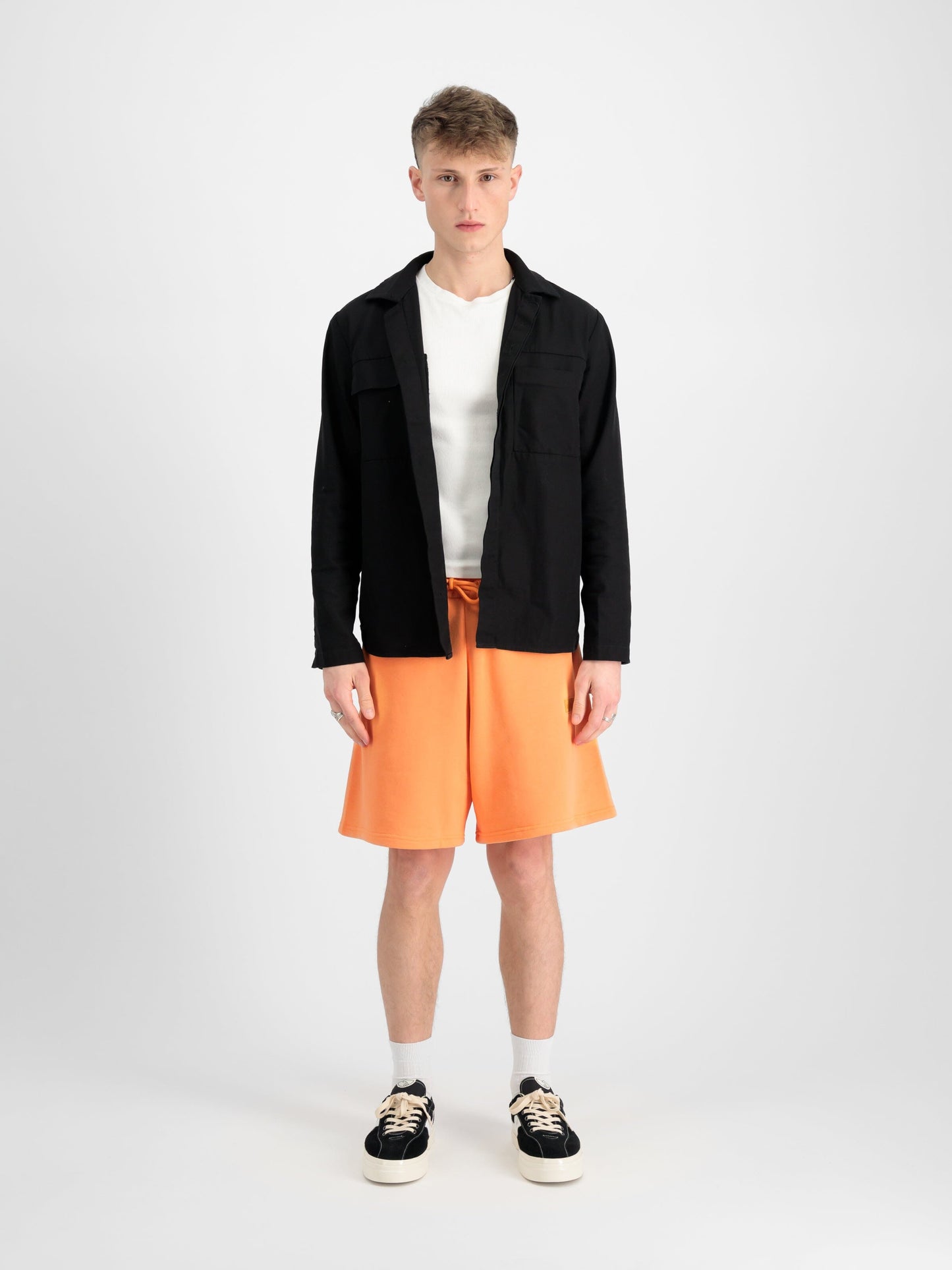 Alpha Industries Alpha Essential Relaxed Short in orange with elastic waistband and drawstring closure.