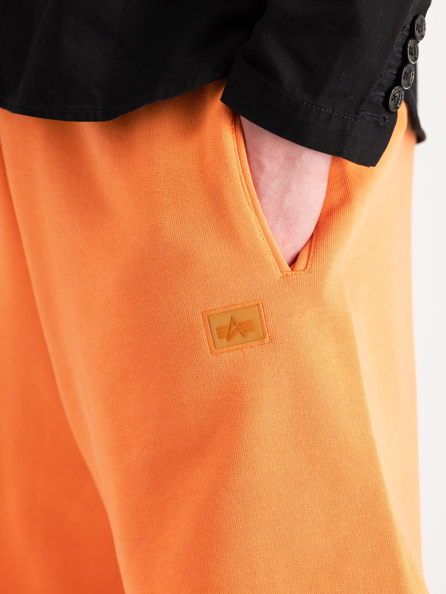 Alpha Industries Alpha Essential Relaxed Shorts in orange cotton blend with small logo patch.