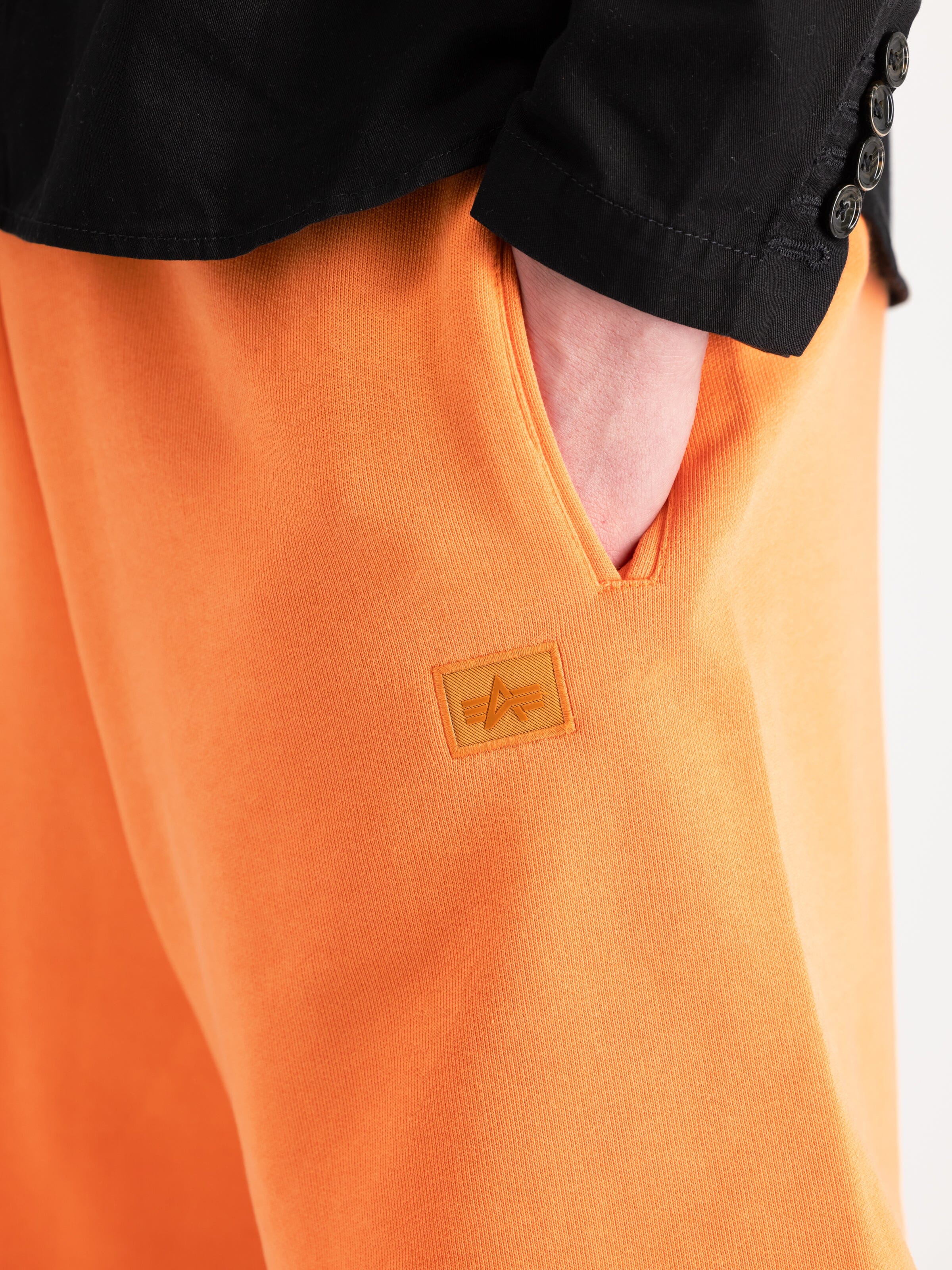 Alpha Industries Alpha Essential Relaxed Shorts in orange cotton blend with small logo patch.
