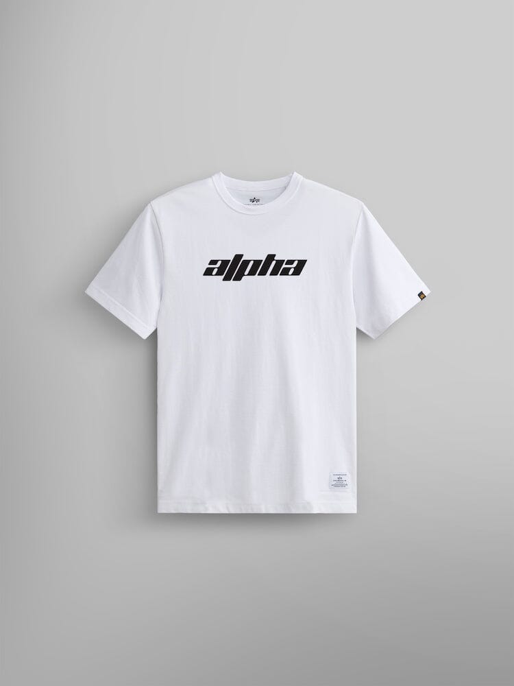 The Alpha Logos Tee by Alpha Industries features the bold Alpha logo in black, prominently on a white tee against a gray backdrop.