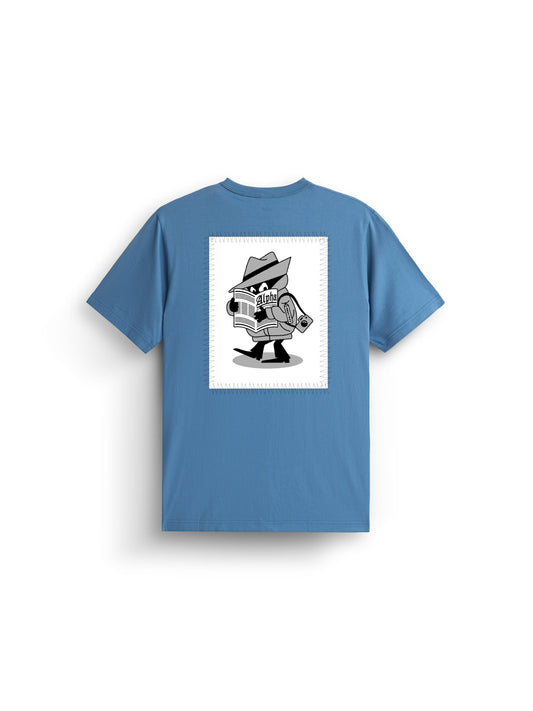Alpha News Patch Tee by Alpha Industries, elemental blue graphic shirt with black and white back print featuring cartoon spy, hat, trench coat, newspaper, and rolled-up document.