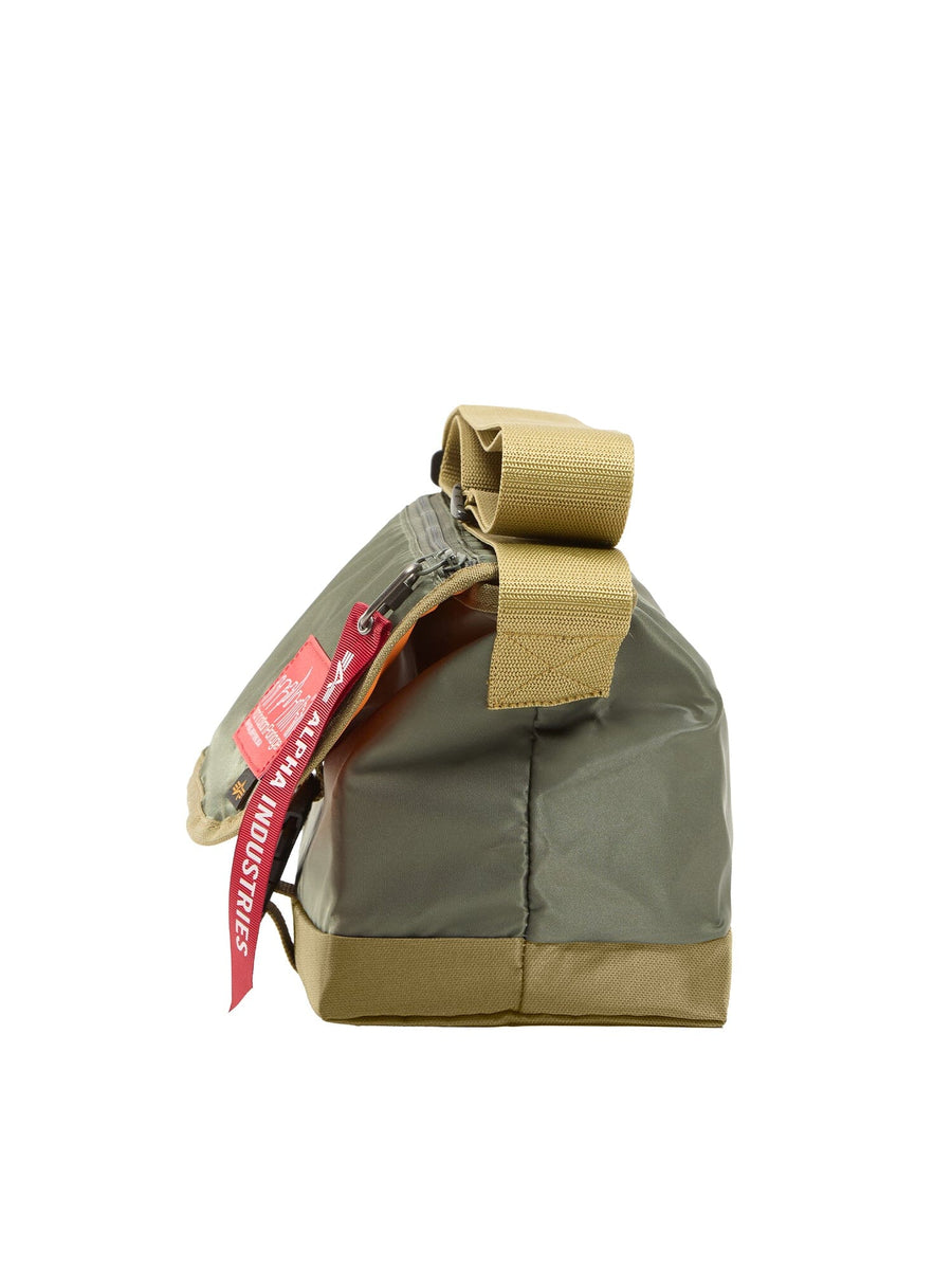 Alpha X Manhattan Portage Nylon Messenger Bag SM by Alpha Industries, olive-green and tan flight nylon pouch with folded top, zipper closure, and red Remove Before Flight tag.