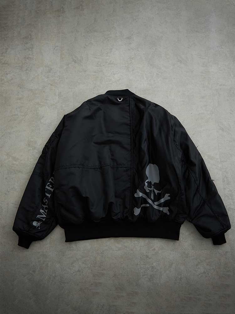 MA-1 Bomber Jacket by Alpha Industries, black, skull and crossbones graphic on back, sleeve text, made in Japan.