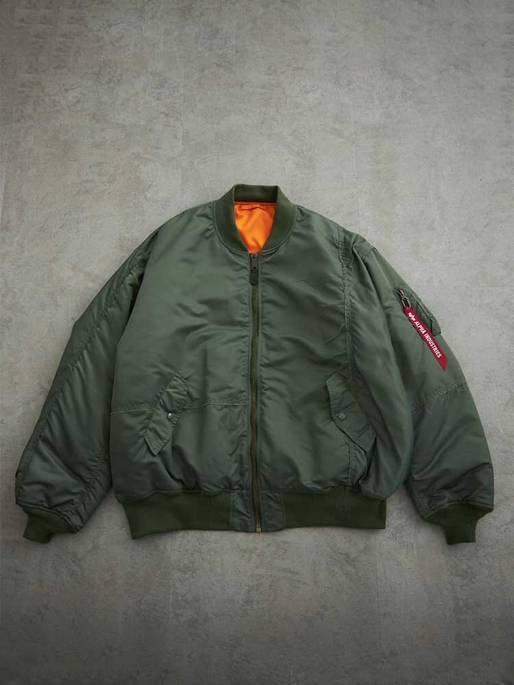 Alpha X Mastermind MA-1 Bomber Jacket by Alpha Industries, olive with orange lining, zip front, side pockets, red sleeve tag.