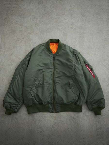 Alpha X Mastermind MA-1 Bomber Jacket by Alpha Industries, olive with orange lining, zip front, side pockets, red sleeve tag.