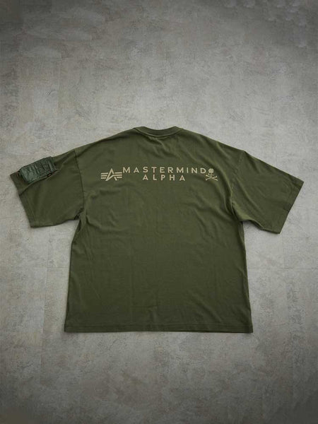 Alpha X Mastermind Tee by Alpha Industries, olive green, back graphics, left sleeve pocket detail, made in Japan.