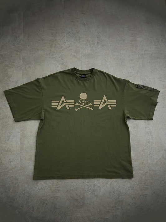 Alpha X Mastermind Tee by Alpha Industries in Olive, features skull and crossbones with arrow graphics, made in Japan.