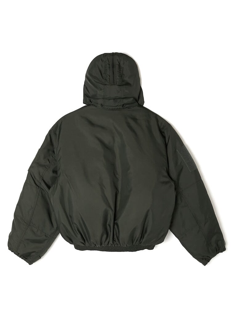 The Alpha x N. Hoolywood CWU-45P w/ Detachable Hood by Alpha Industries is a dark green jacket inspired by the classic flight jacket design, featuring elastic cuffs and hem. It is showcased from the back.