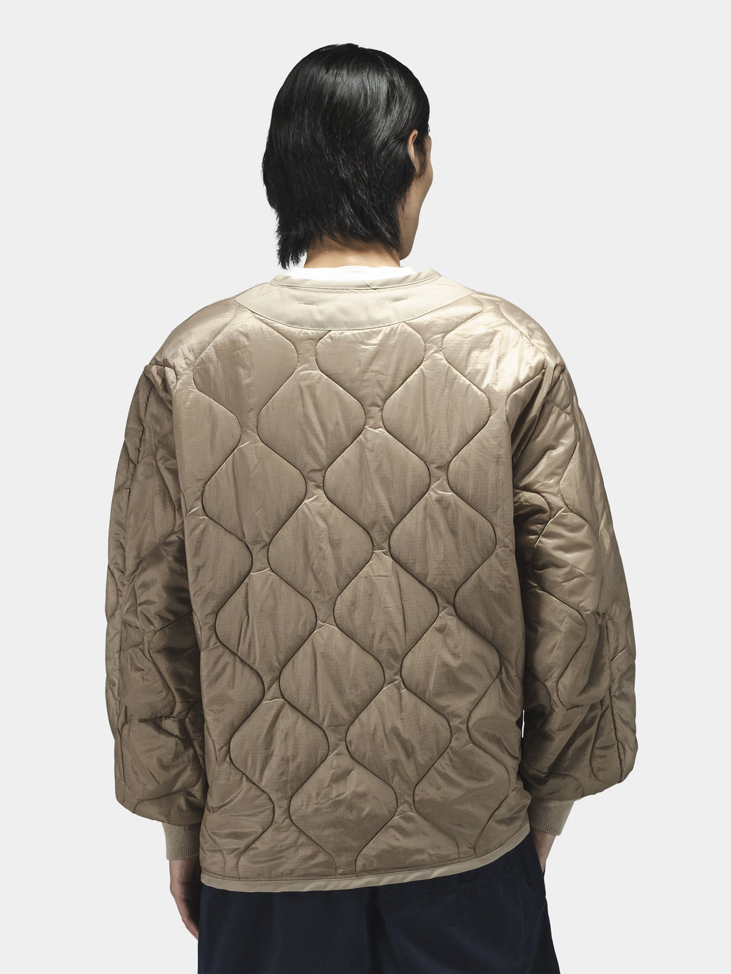 Alpha Industries Als/92 Liner in tan, paired with dark pants.
