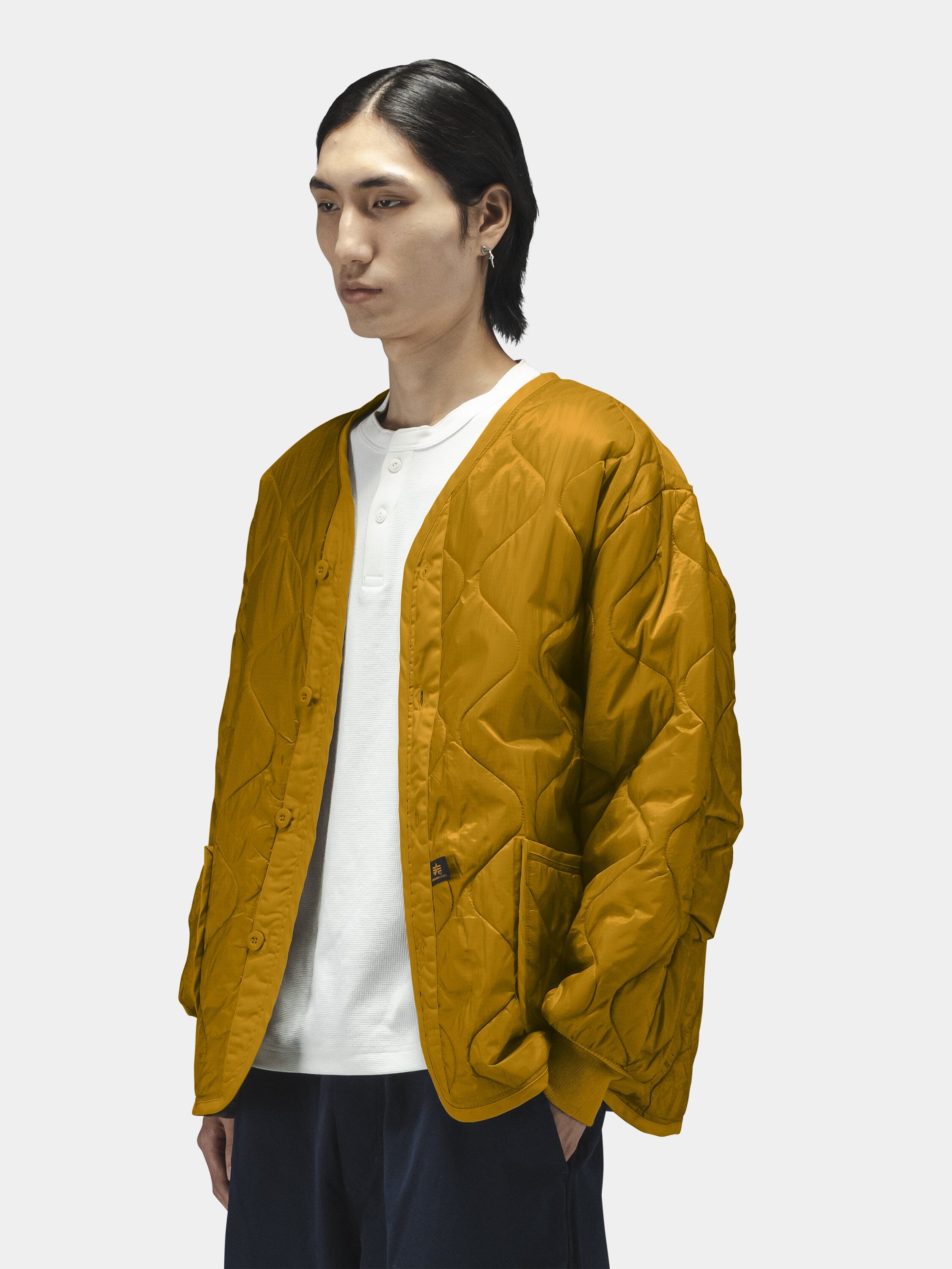 Alpha Industries Als/92 Liner in mustard yellow with quilted design.