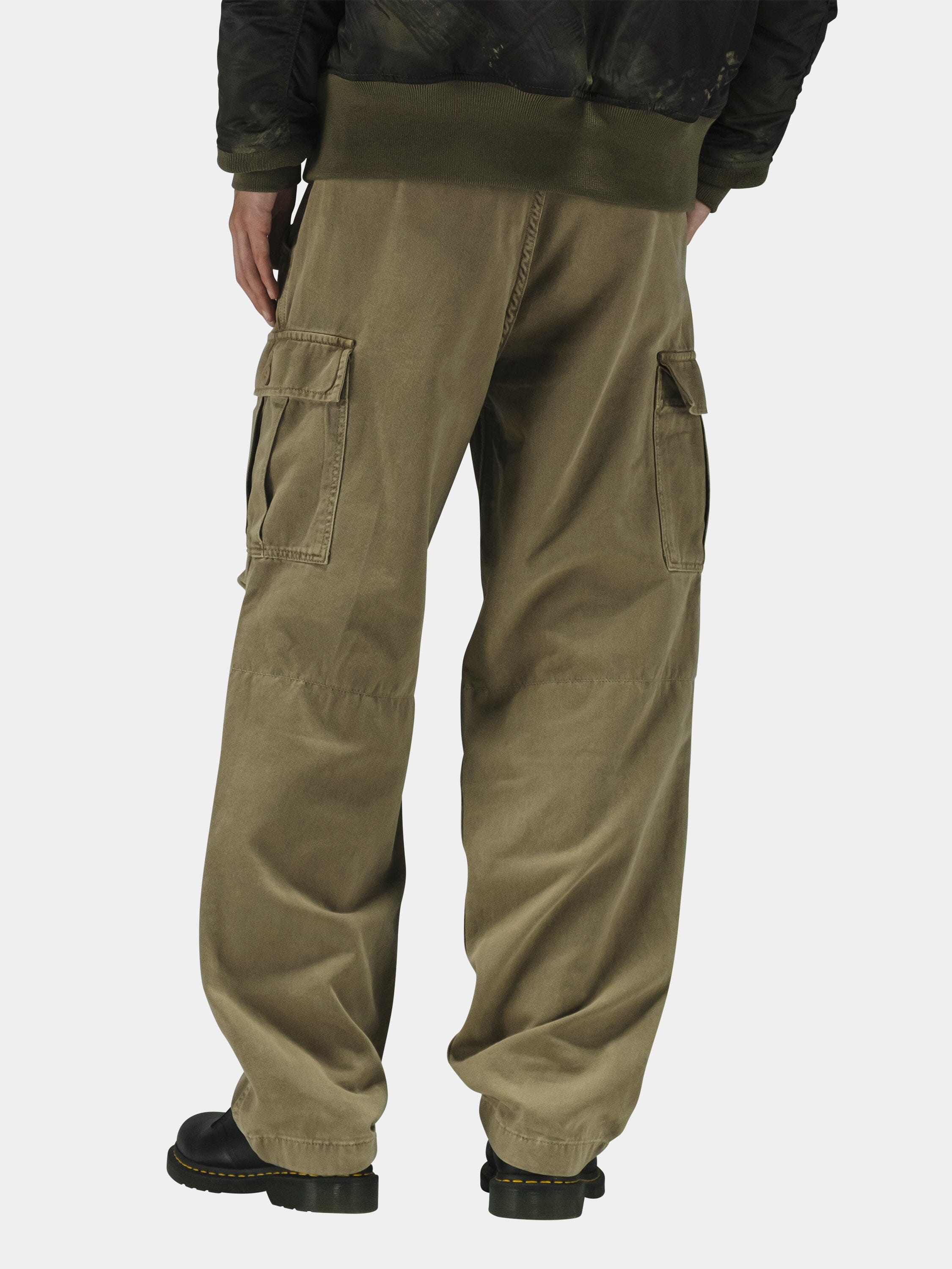 Alpha Industries Bdu Cargo Pant in black with cargo pockets, paired with black boots and a dark jacket.