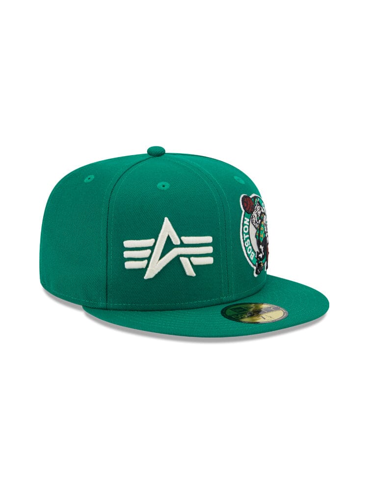 This Boston Celtics x Alpha x New Era 59FIFTY Fitted Cap by Alpha Industries showcases a green design with a white embroidered team logo and circular emblem on the side. It features a flat brim and snapback design, echoing the rugged style of Alpha Industries.