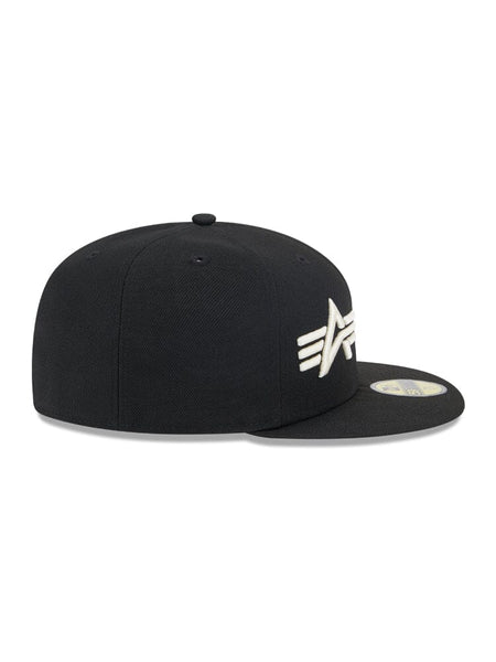 Side view of the Brooklyn Nets x Alpha x New Era 59Fifty fitted cap showing a flat brim and the white embroidered logo of Alpha Industries on the front.