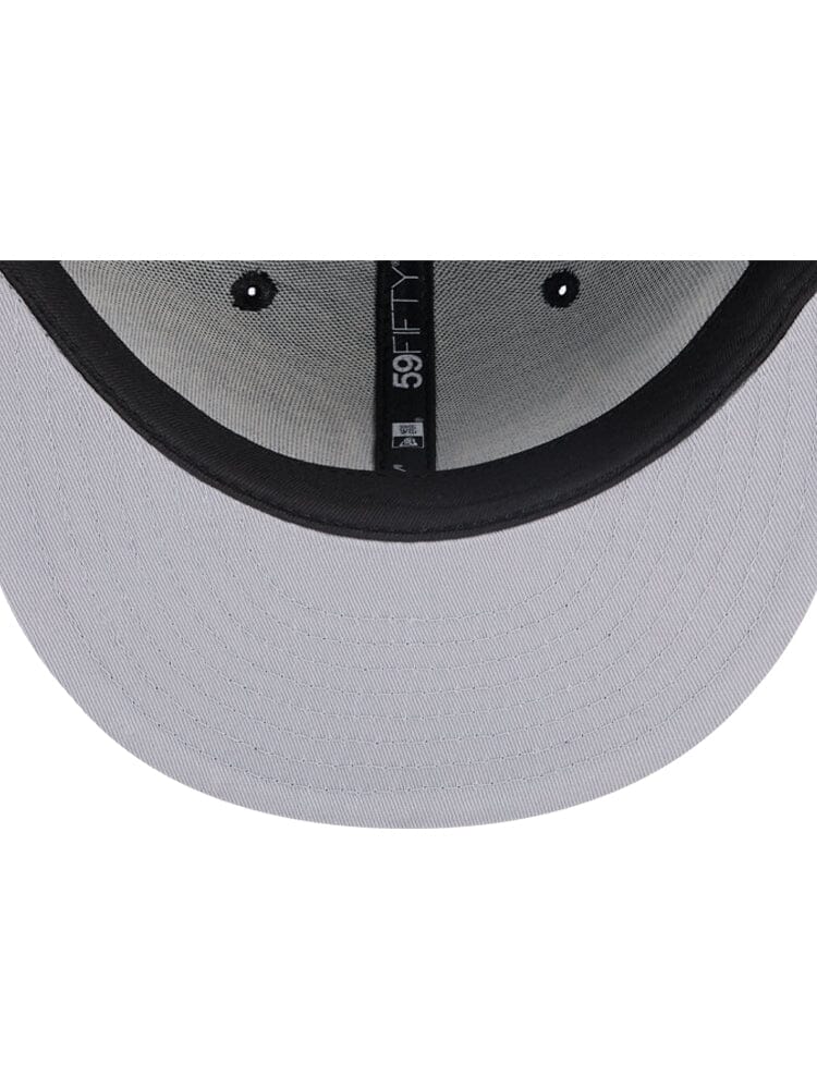 The interior of the Brooklyn Nets x Alpha x New Era 59Fifty Fitted Cap, designed by Alpha Industries / NE-NBA, showcases meticulous stitching and a size label. It embodies the iconic structure characteristic of an Alpha Industries creation, with plenty of room on the exterior for a team logo.